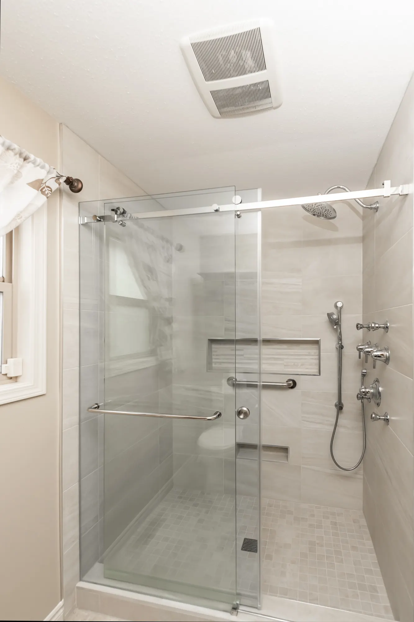 Renovated bathroom with a tiled glass shower and quartz vanity by Master Painting & Renovations, Chilliwack BC