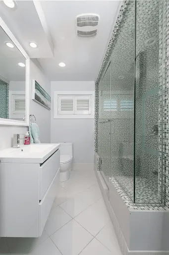 Bright ensuite with a mosaic-tiled walk-in shower and wall-mounted vanity