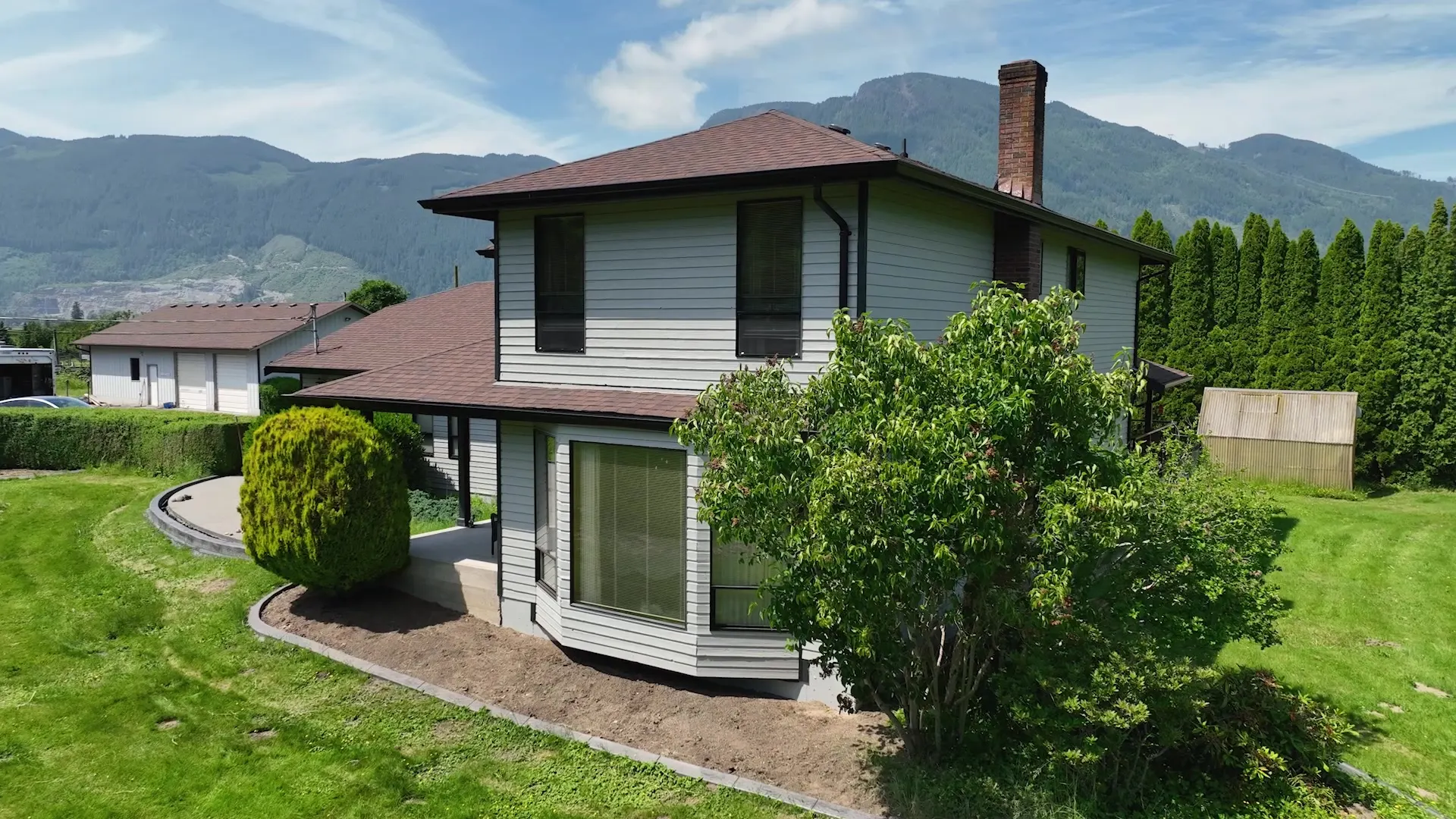 Aerial angle of the renovated exterior against the mountains