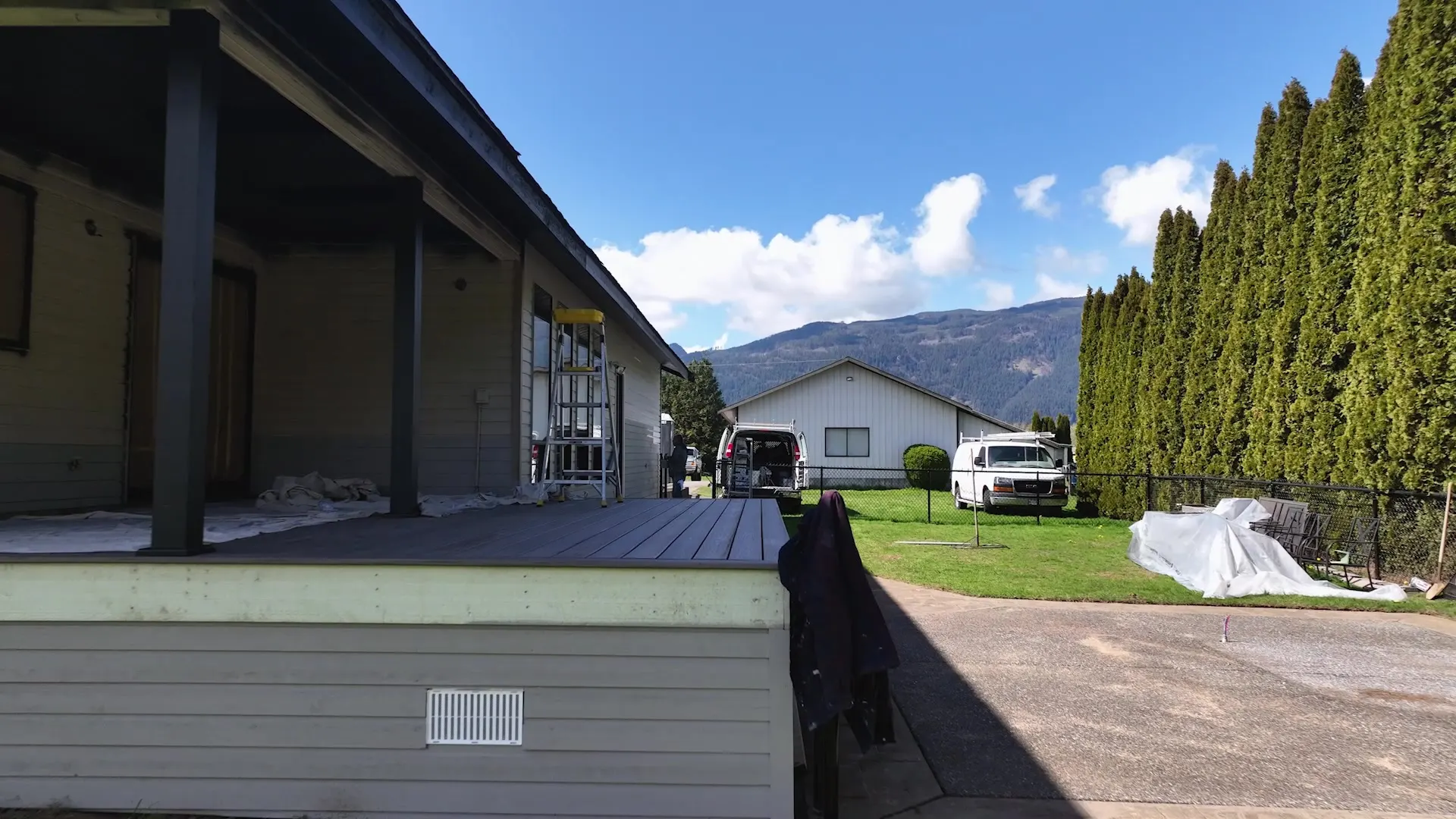 Covered outdoor living area with fresh grey siding