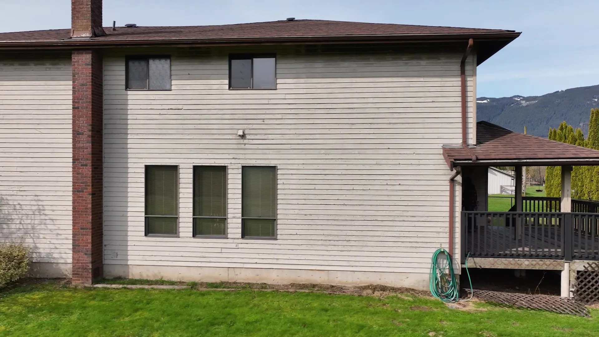 Side elevation showing the consistent light-grey siding and trim