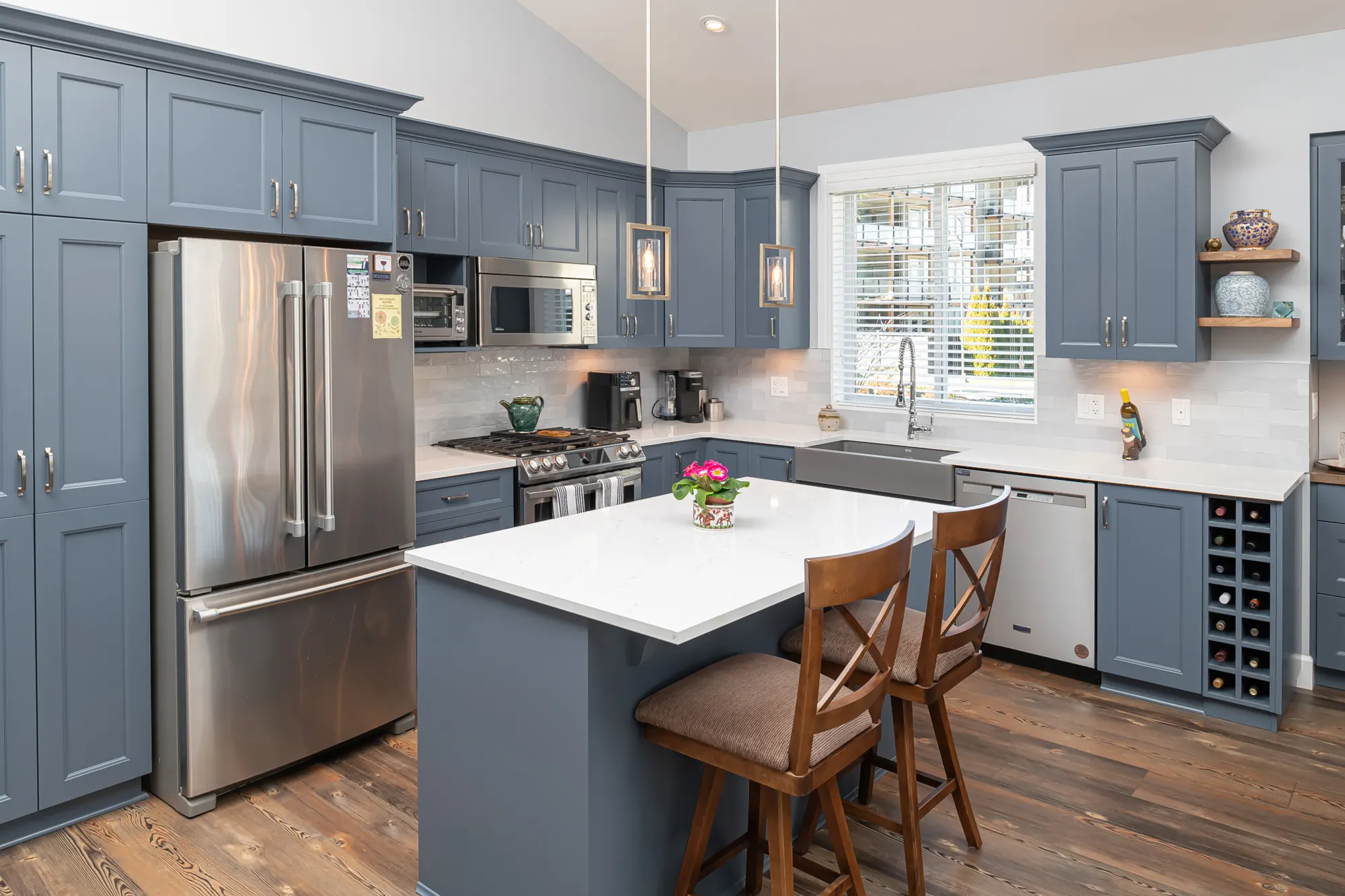 Blue-cabinet kitchen renovation with quartz island in Chilliwack by Master Painting & Renovations