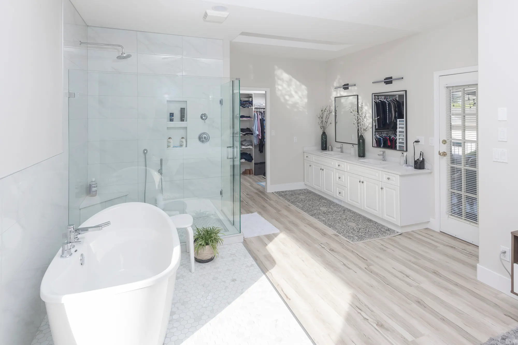 Ensuite bathroom with a freestanding tub, frameless glass shower, and double vanity