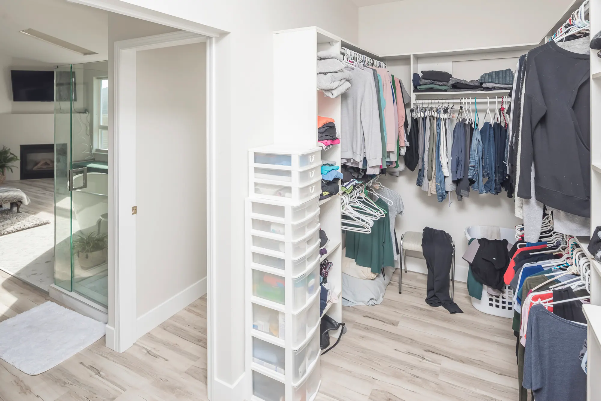 Fitted walk-in closet with custom shelving and hanging space