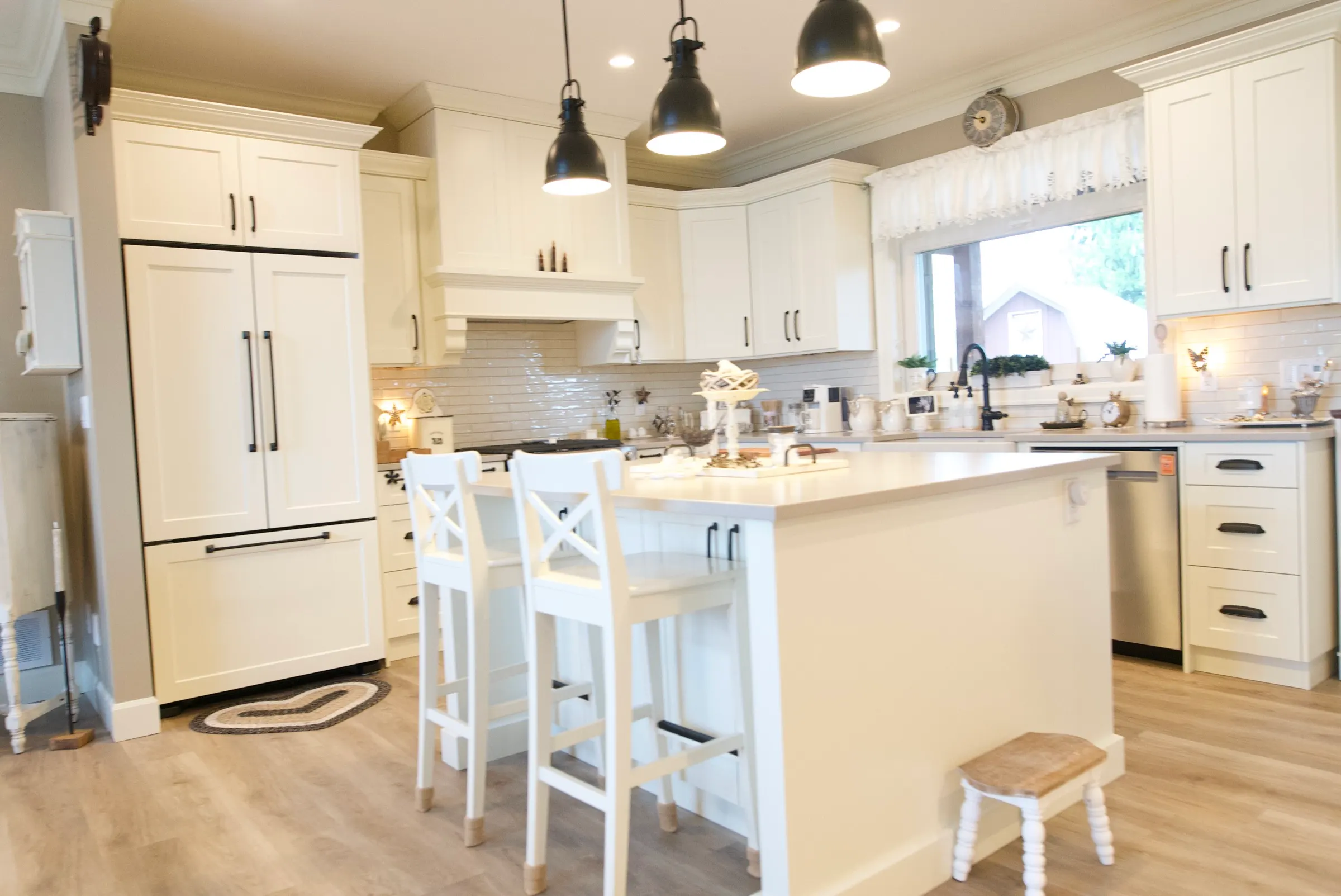 Kitchen looking toward a built-in pantry and full-height white cabinetry