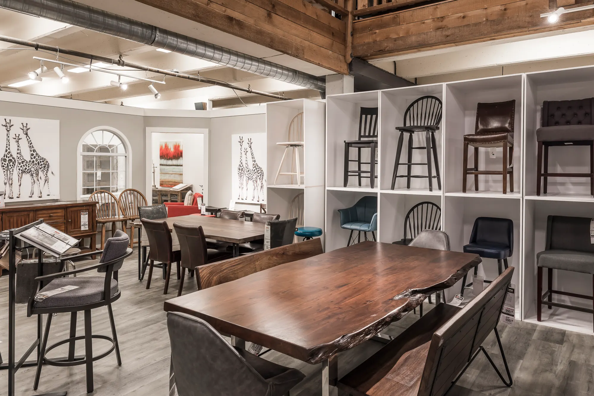 Live-edge dining tables and a wall of display cubbies for bar stools
