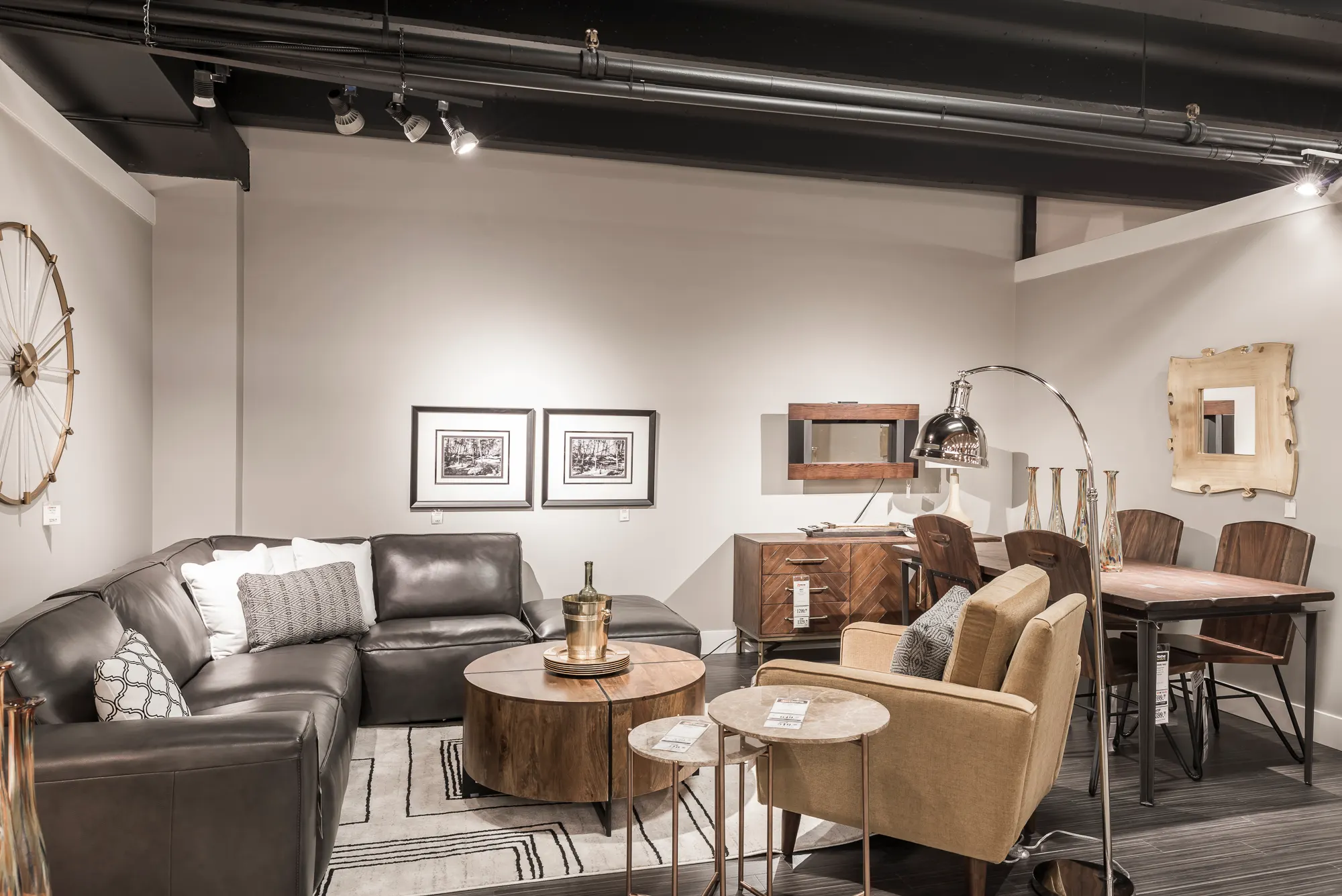 Leather seating group displayed against clean gallery walls with framed art