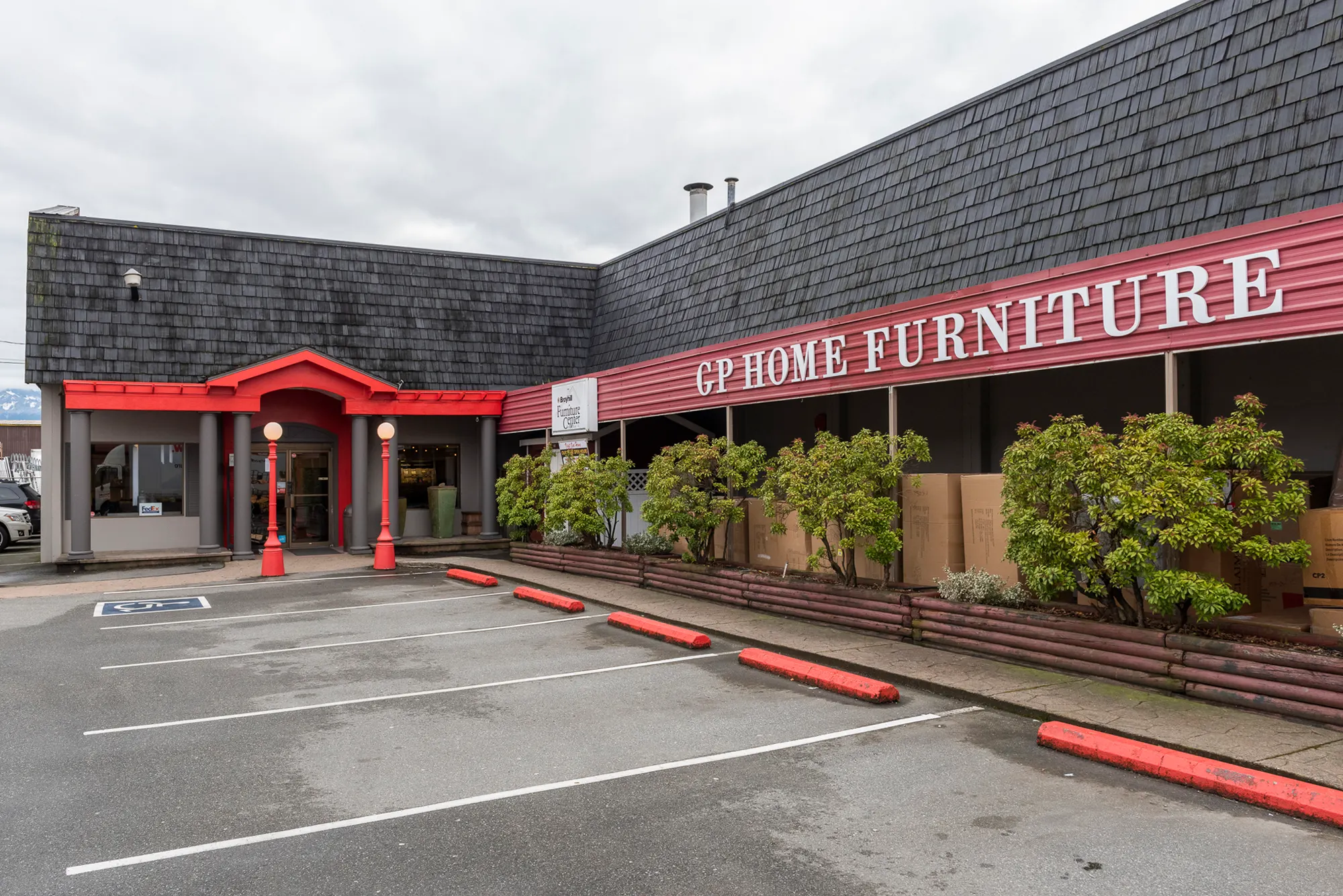 GP Home Furniture storefront with fresh paint, red accents, and tidy landscaping