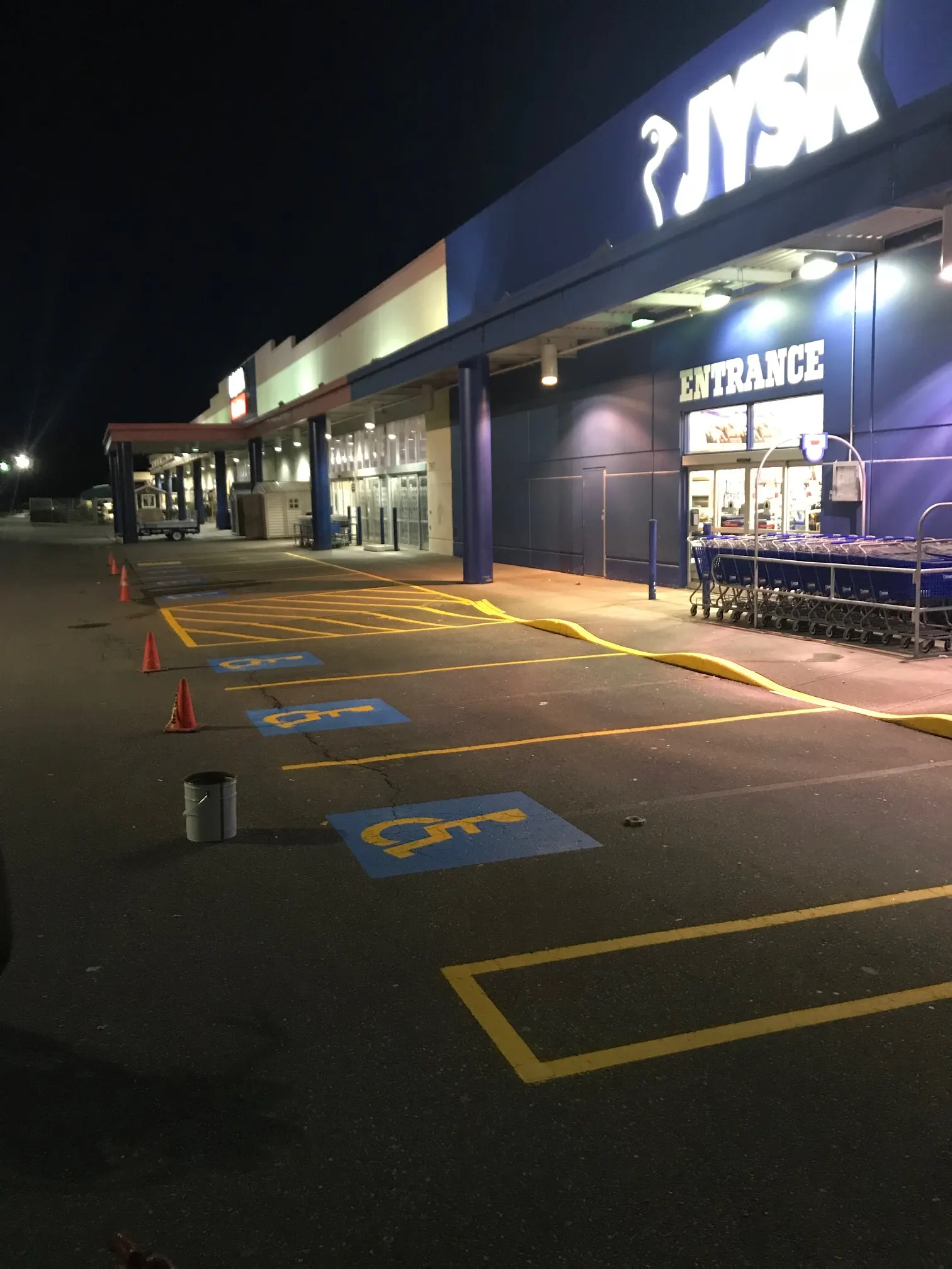 Freshly painted accessible parking spaces with compliant signage symbols by Master Painting & Renovations