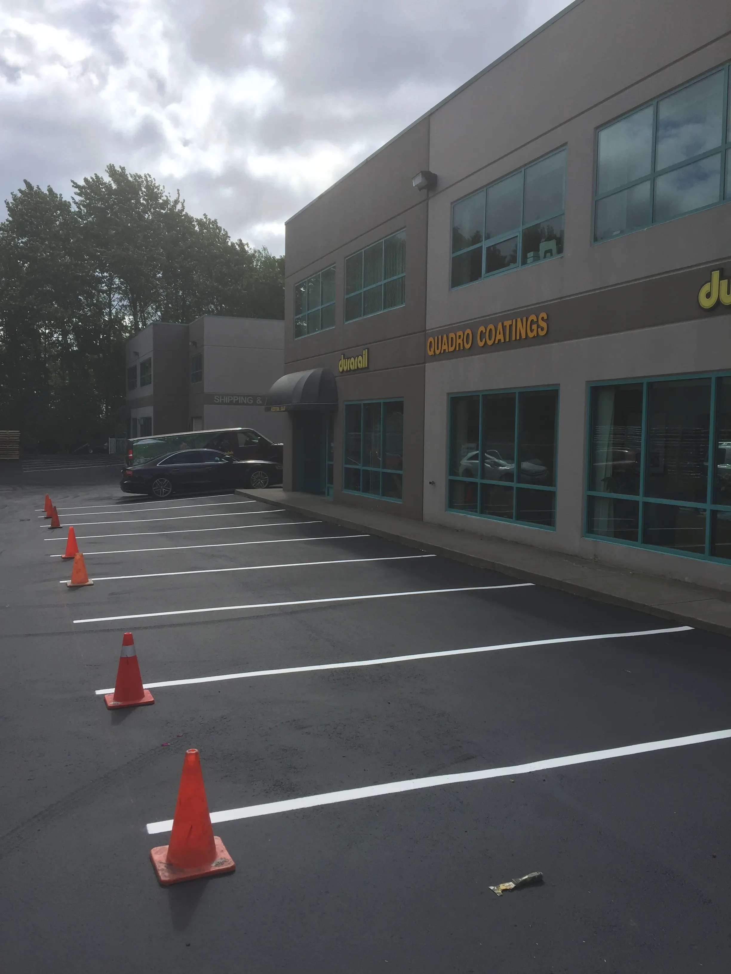 Freshly painted numbered parking stalls at an industrial building by Master Painting & Renovations