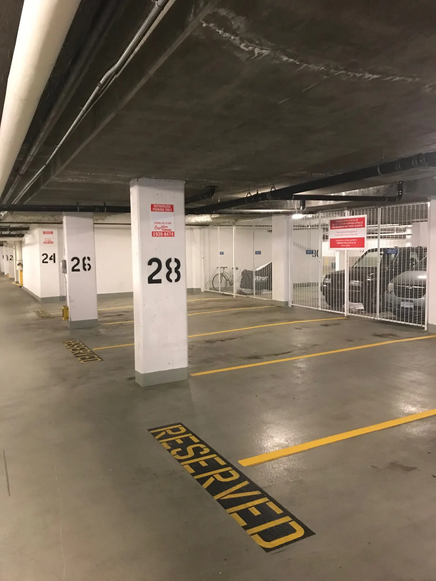 Freshly painted numbered underground parkade stalls by Master Painting & Renovations