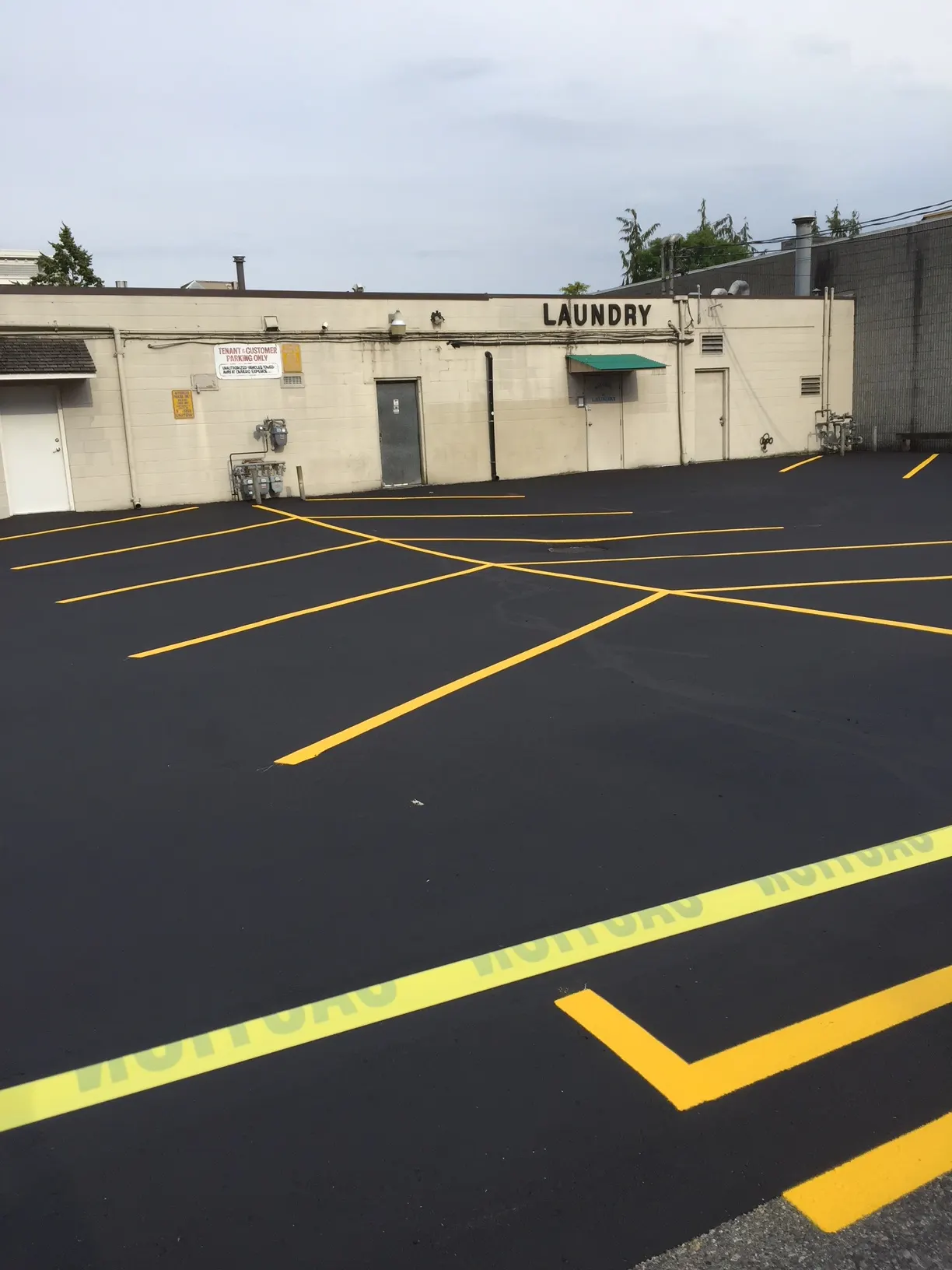 Freshly painted parking stall striping at a retail plaza in the Fraser Valley by Master Painting & Renovations
