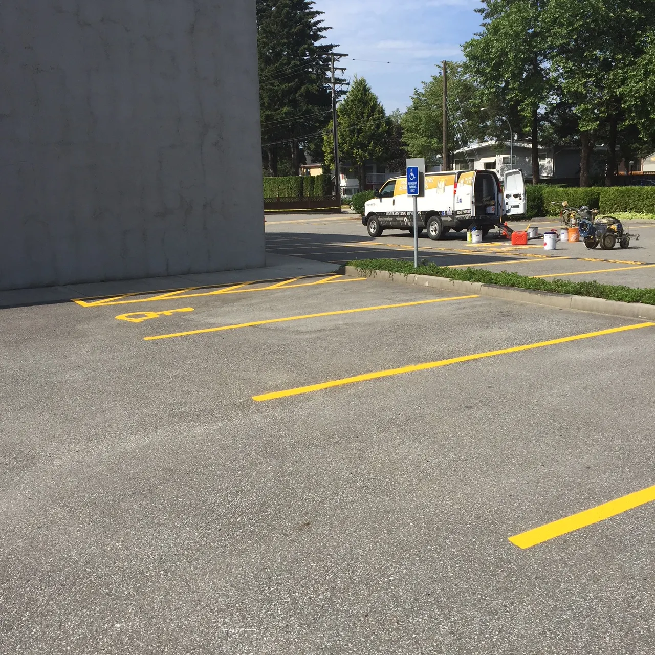 A Master Painting & Renovations line painting truck on site at an accessible parking stall