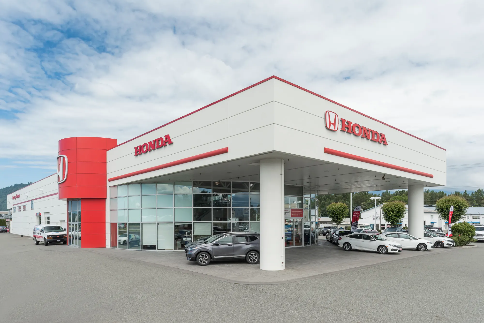 White canopy corner with the Honda sign over vehicles on display