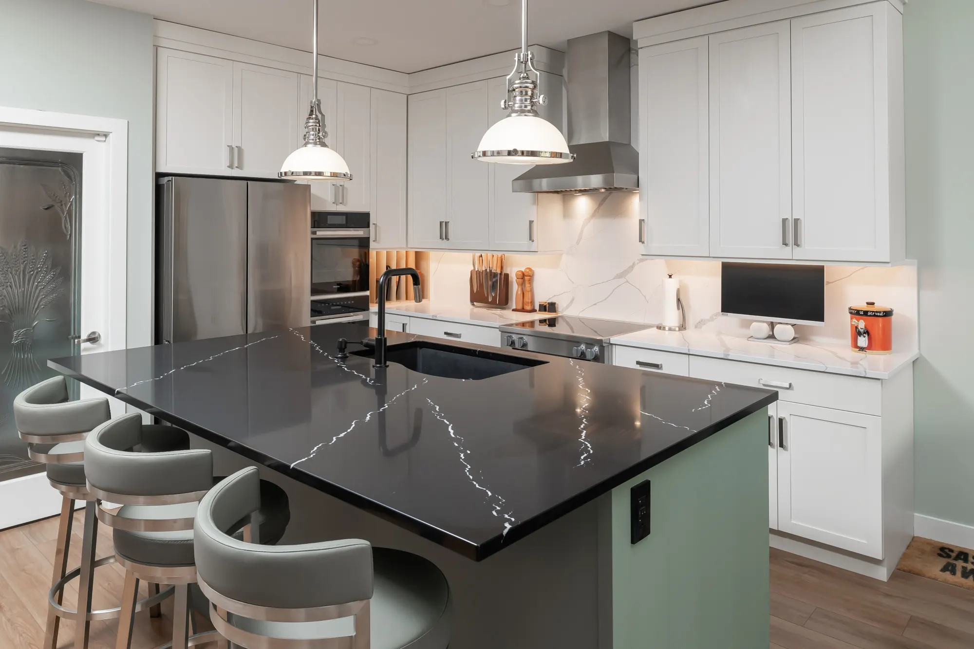 Renovated kitchen with pale cabinetry and a quartz island by Master Painting & Renovations, Chilliwack BC