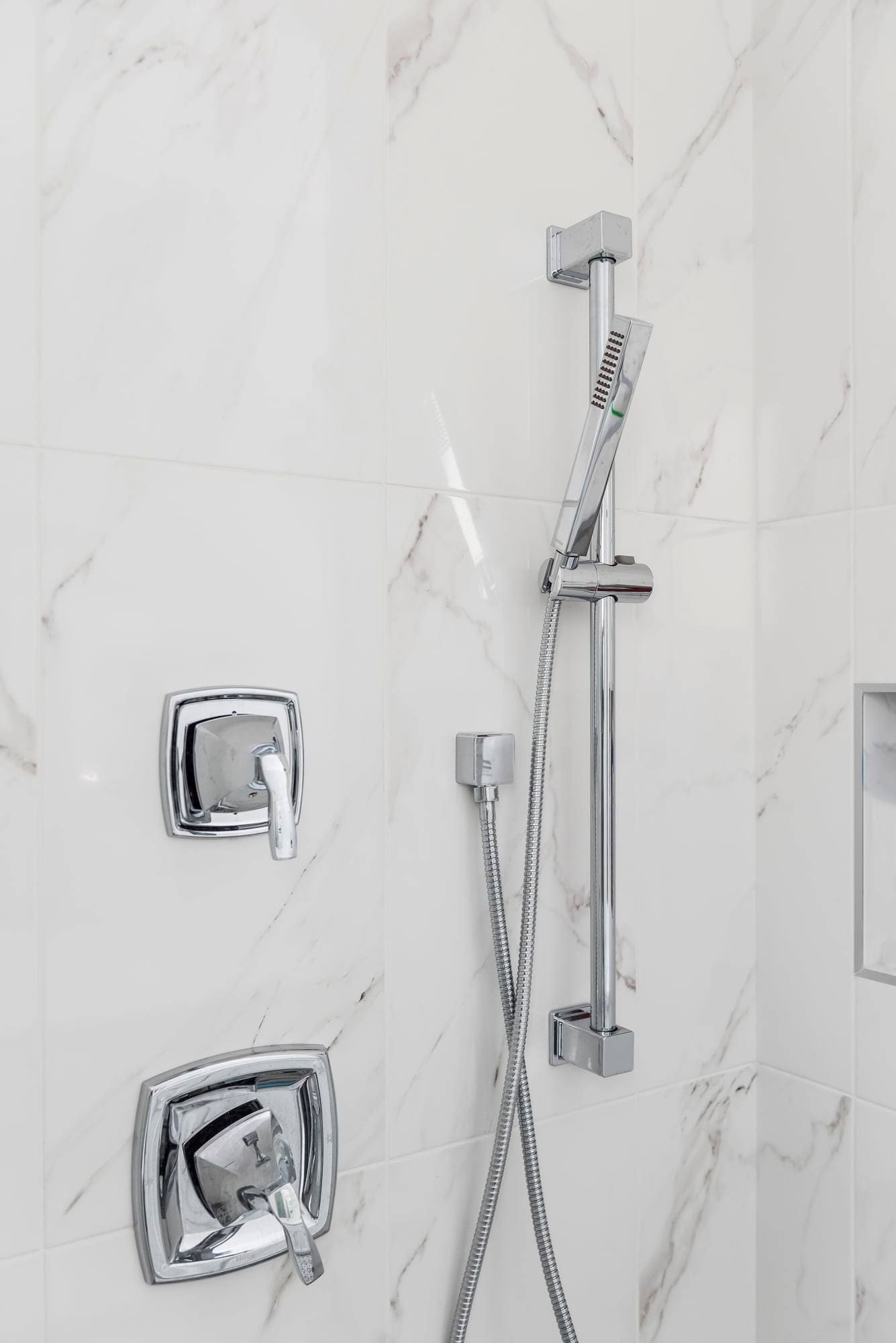 Marble shower with chrome fixtures
