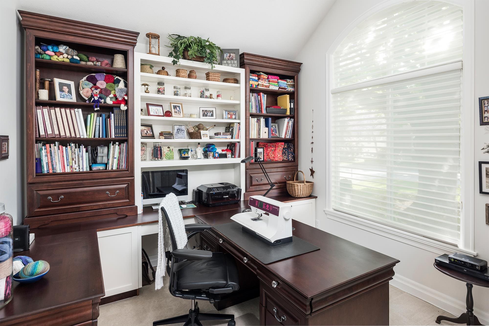 Craft room with L-shaped desk built-in bookshelves and sewing station Chilliwack BC