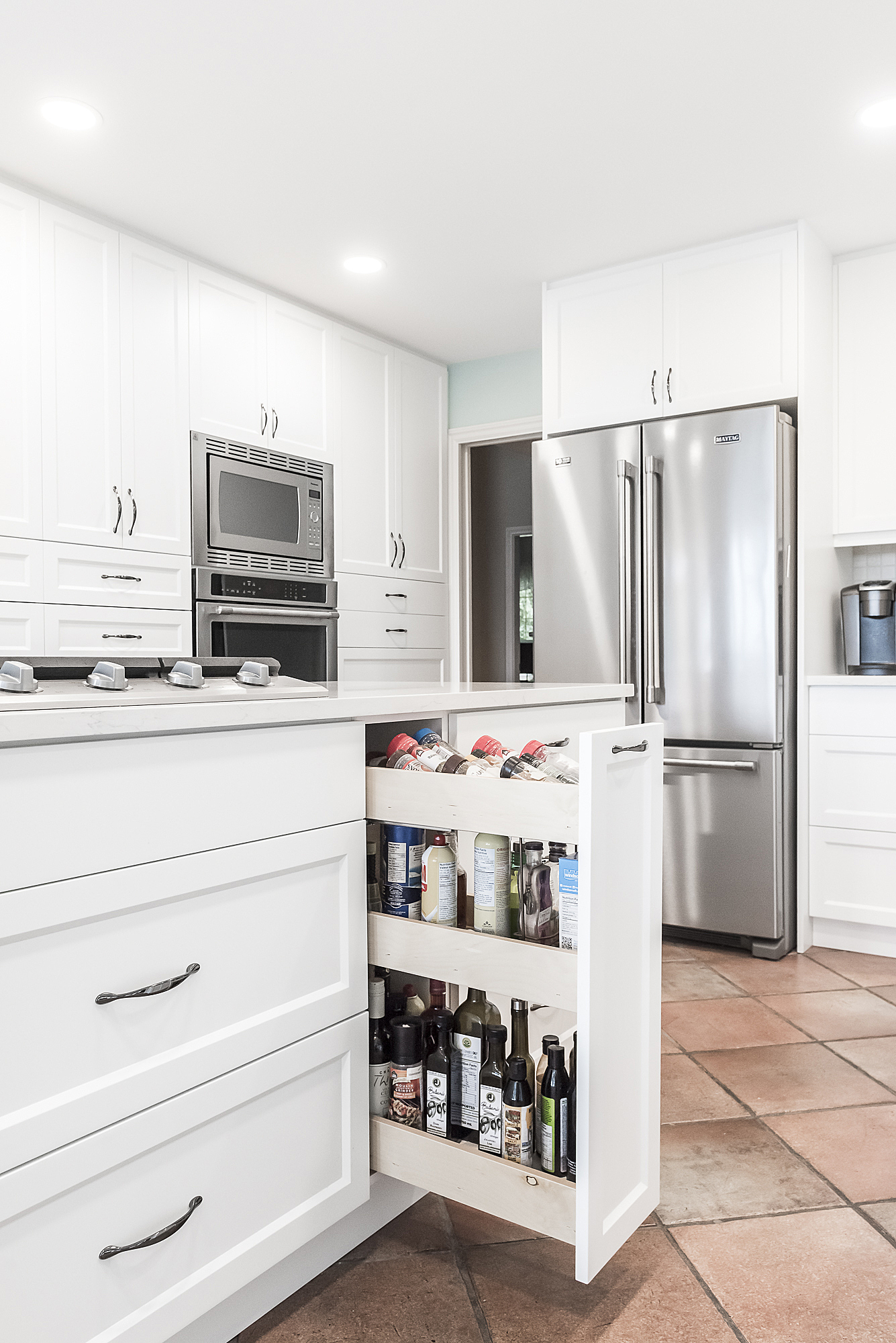 White kitchen with pull-out spice rack storage