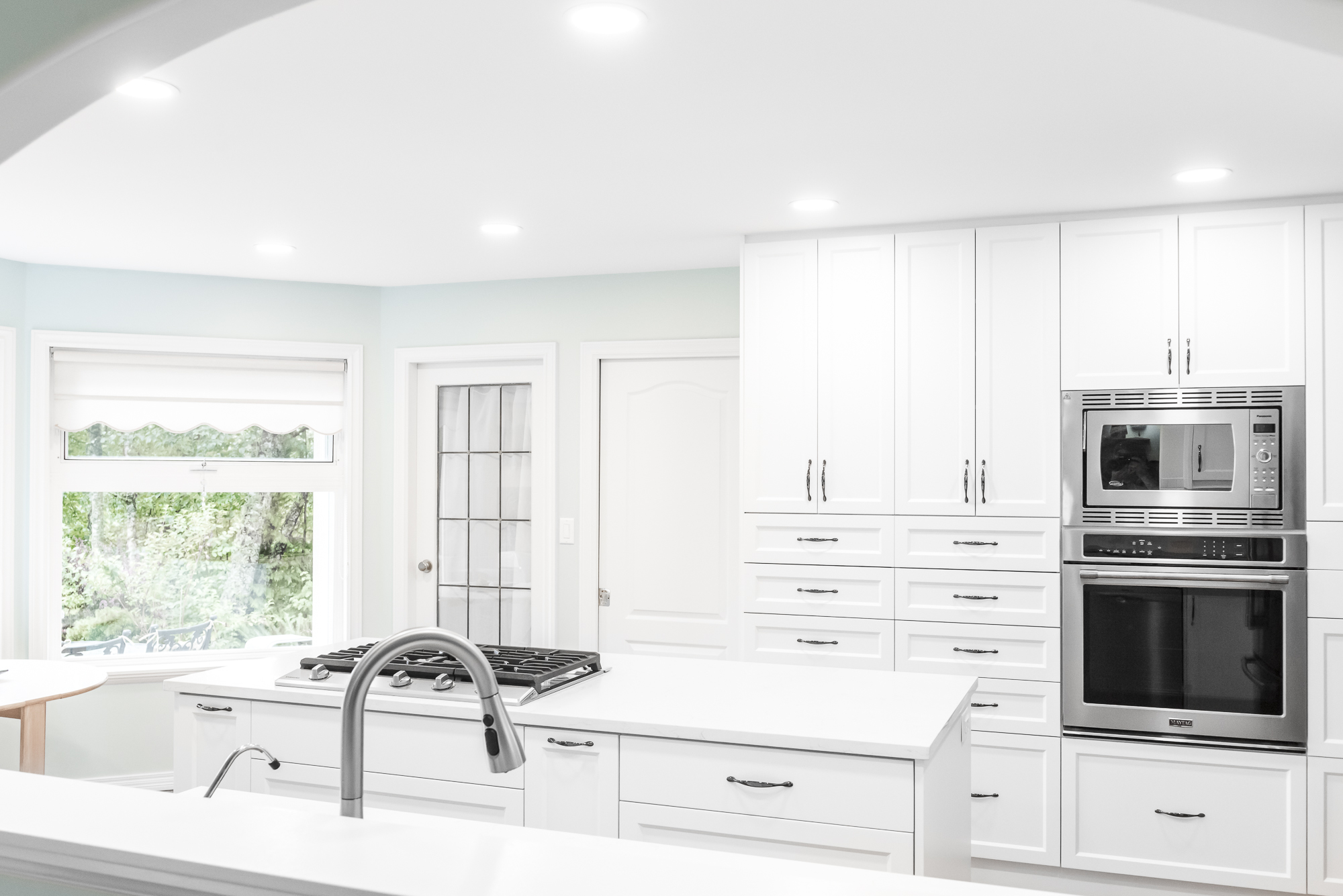 White kitchen with stainless appliances