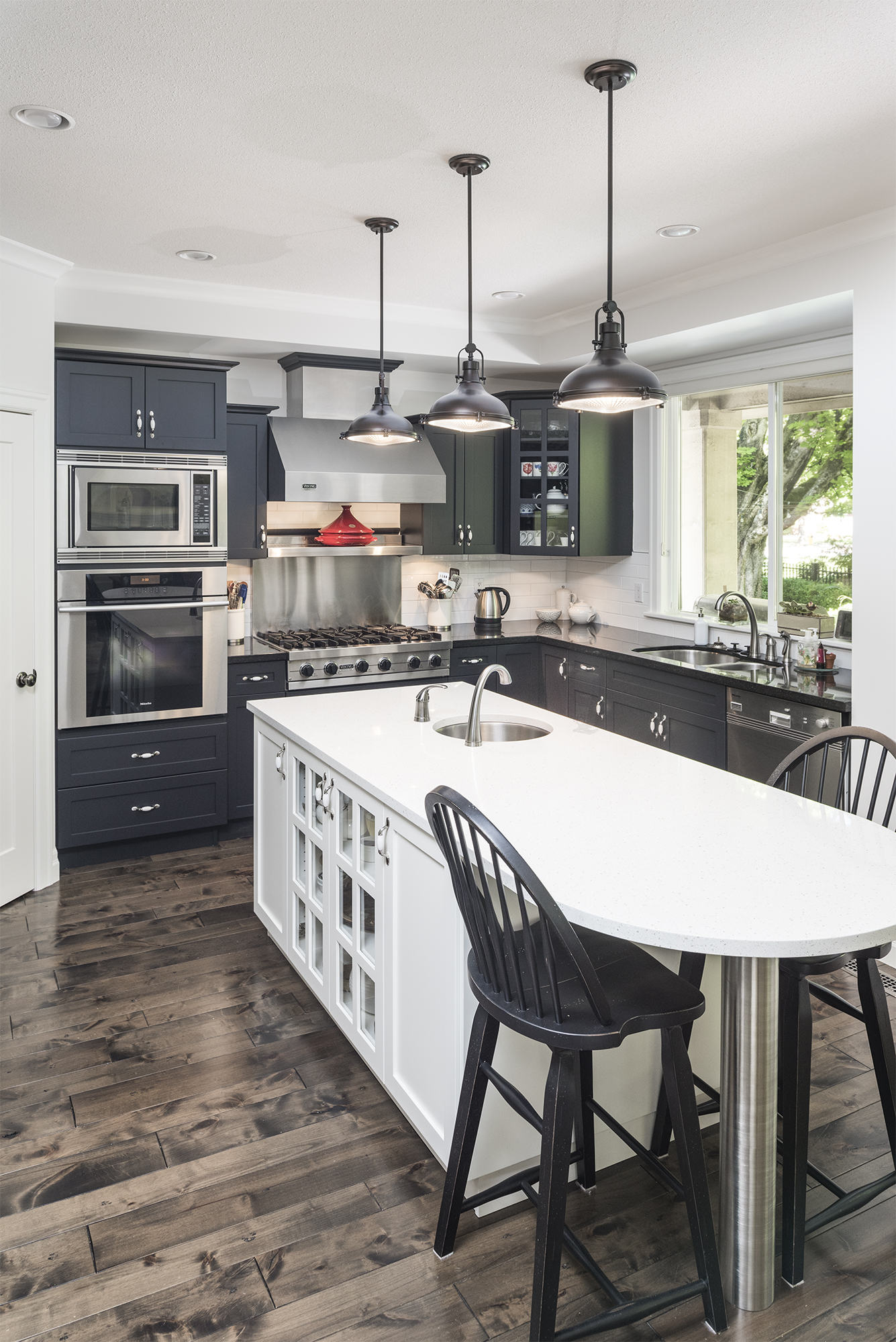 Kitchen with dark cabinets and pendant lights