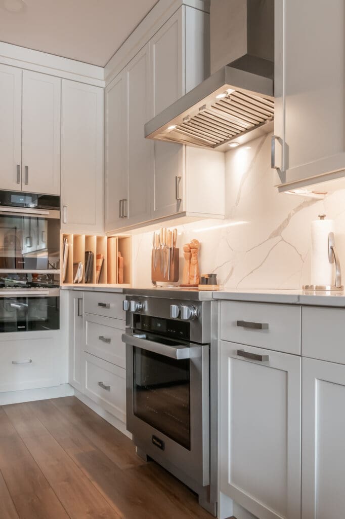Person cooking in modern kitchen with professional-grade appliances