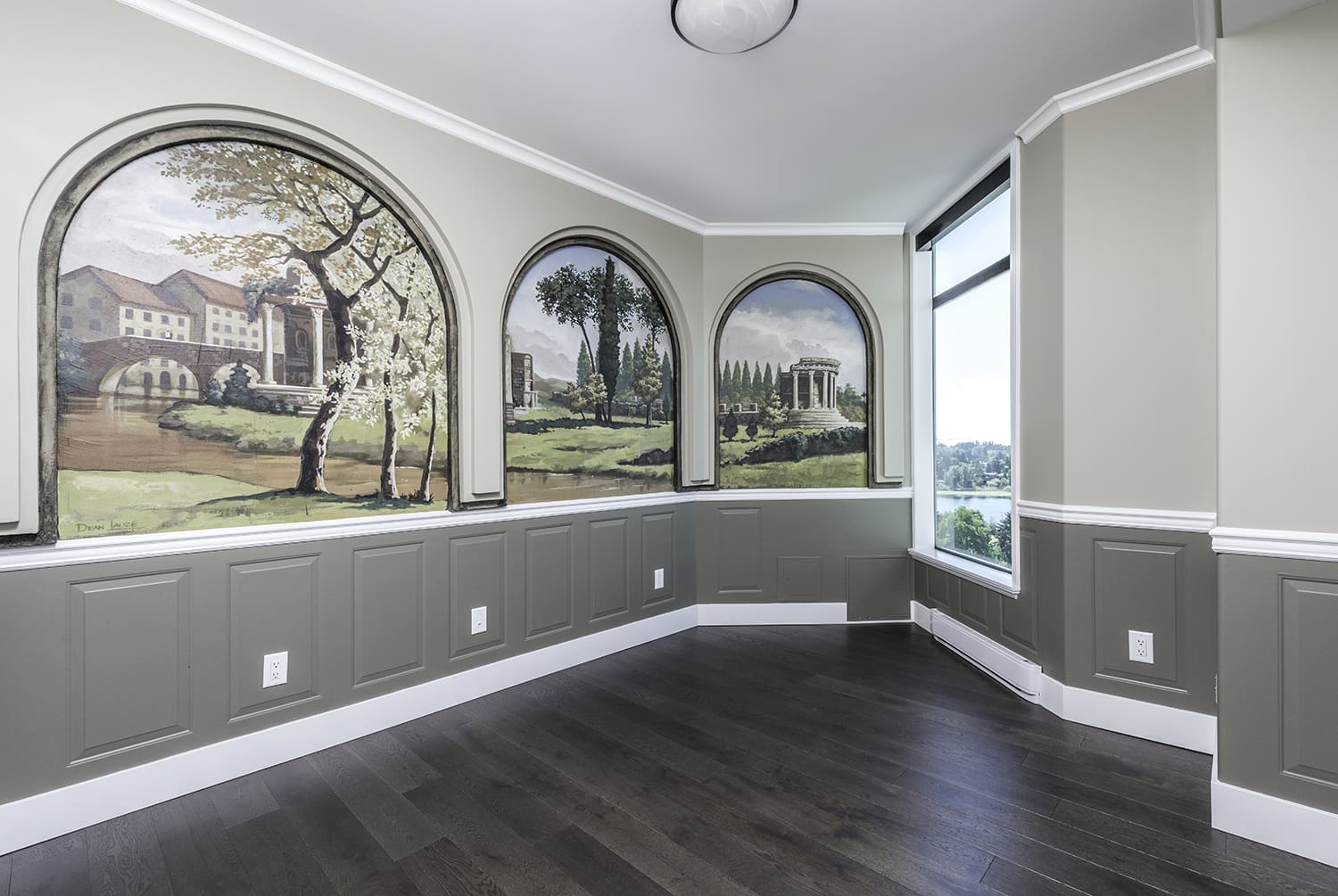 Custom-painted feature wall in Abbotsford home with mural artwork, wainscoting, and precise two-tone paint finish showcasing high-end craftsmanship and detail