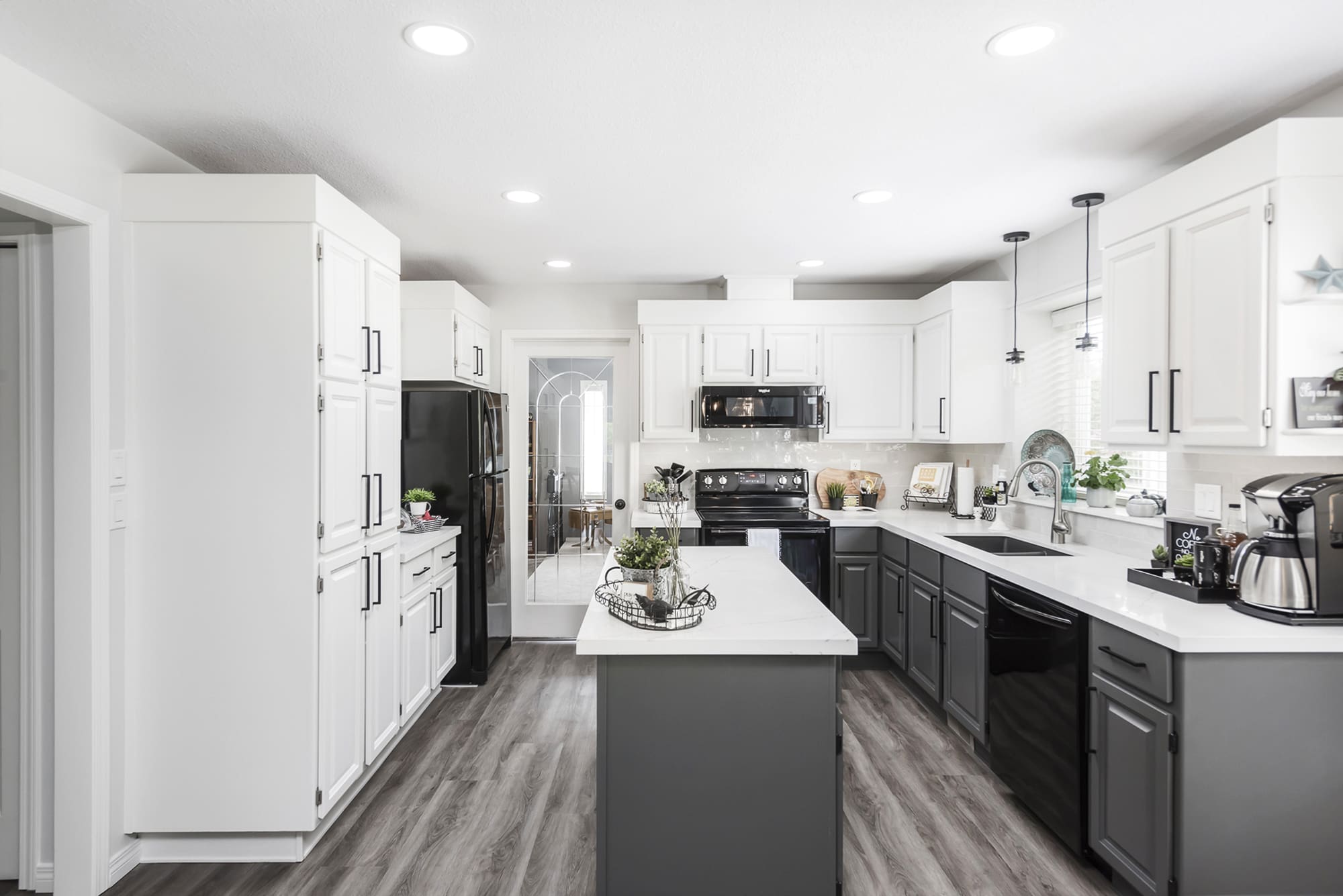 Modern Chilliwack kitchen with two-tone cabinet finishes - white upper cabinets and charcoal lower cabinets with satin finish