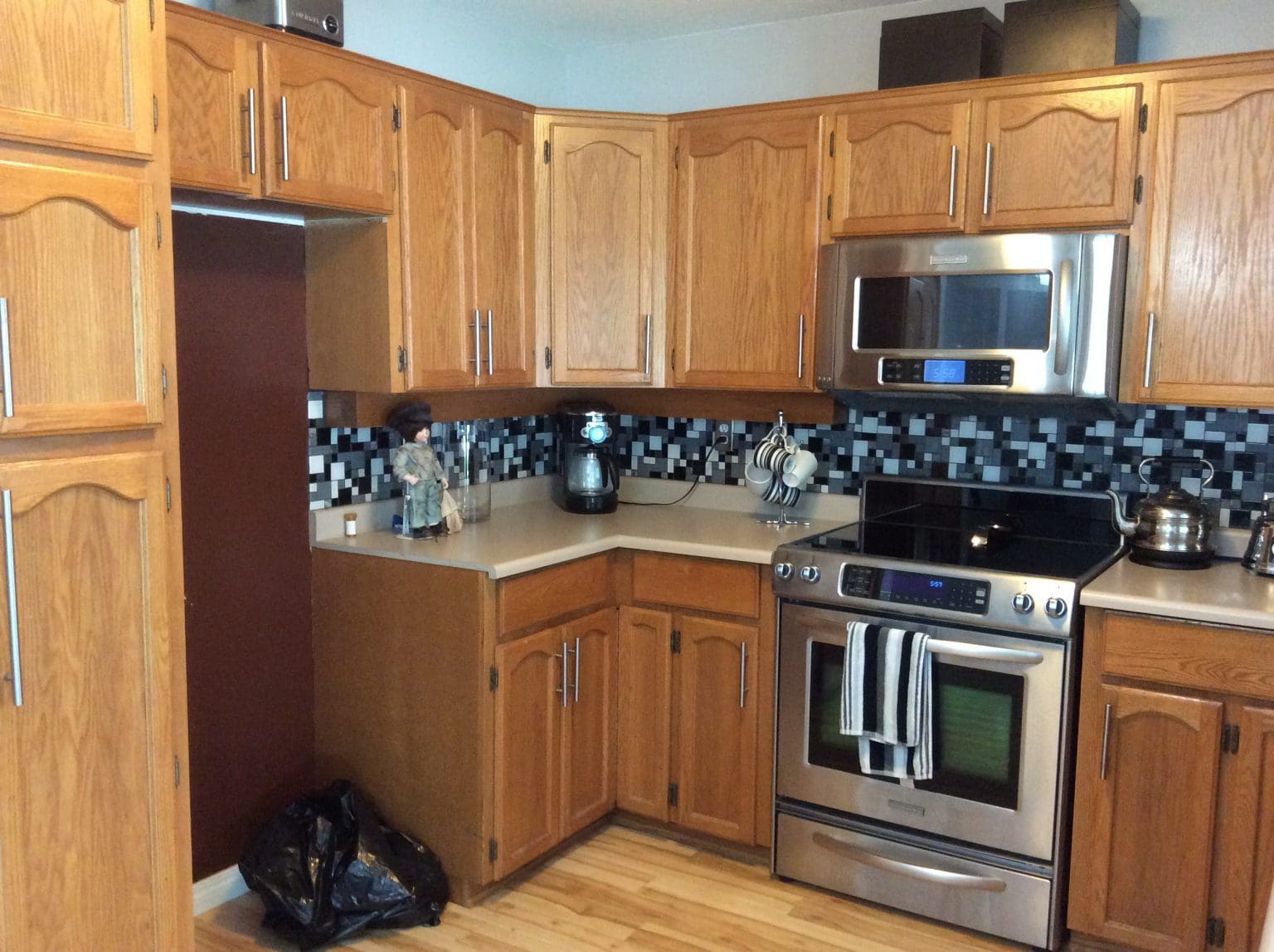 Before renovation - outdated kitchen with wooden cabinets