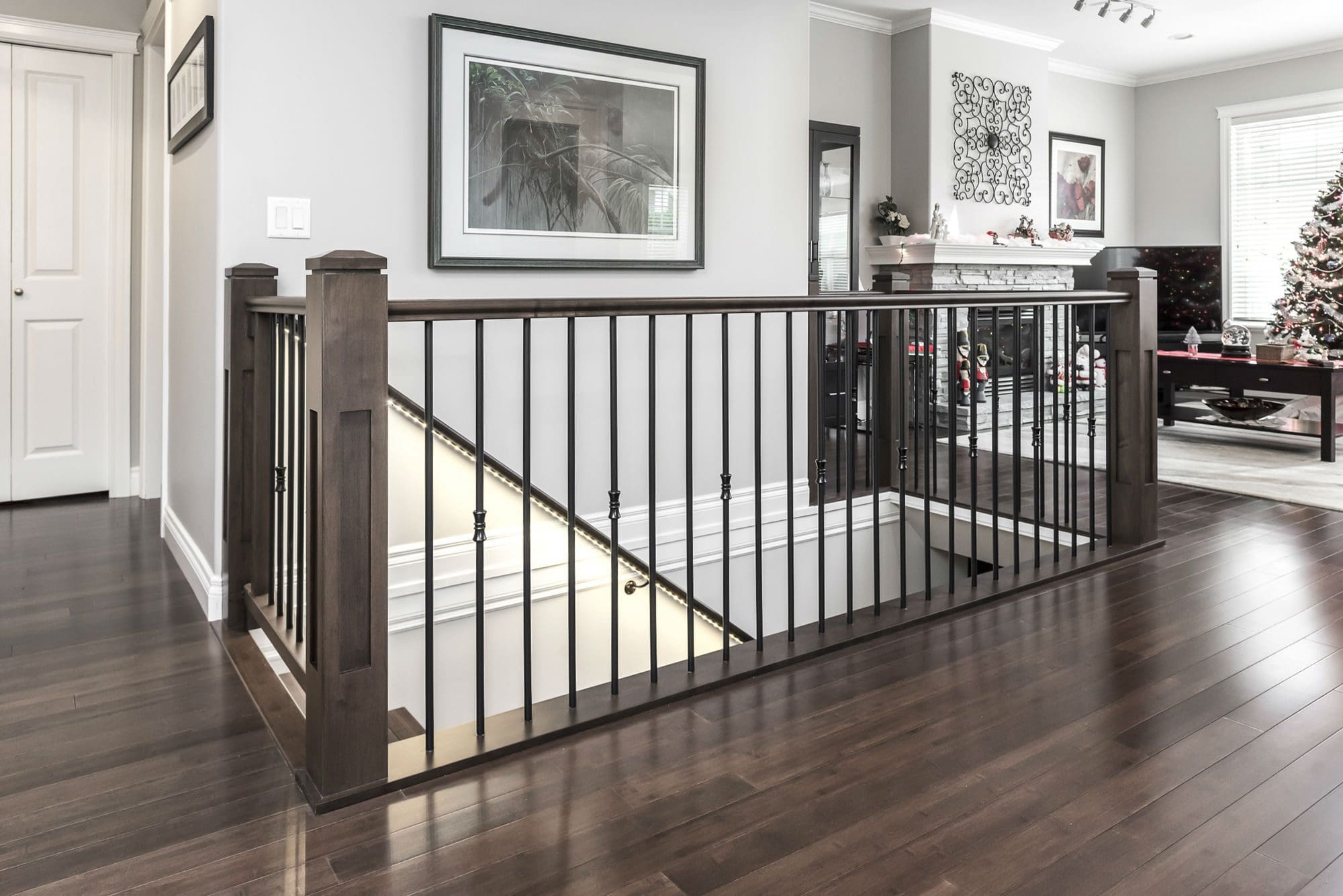 Staircase railing with stone fireplace living room Chilliwack renovation