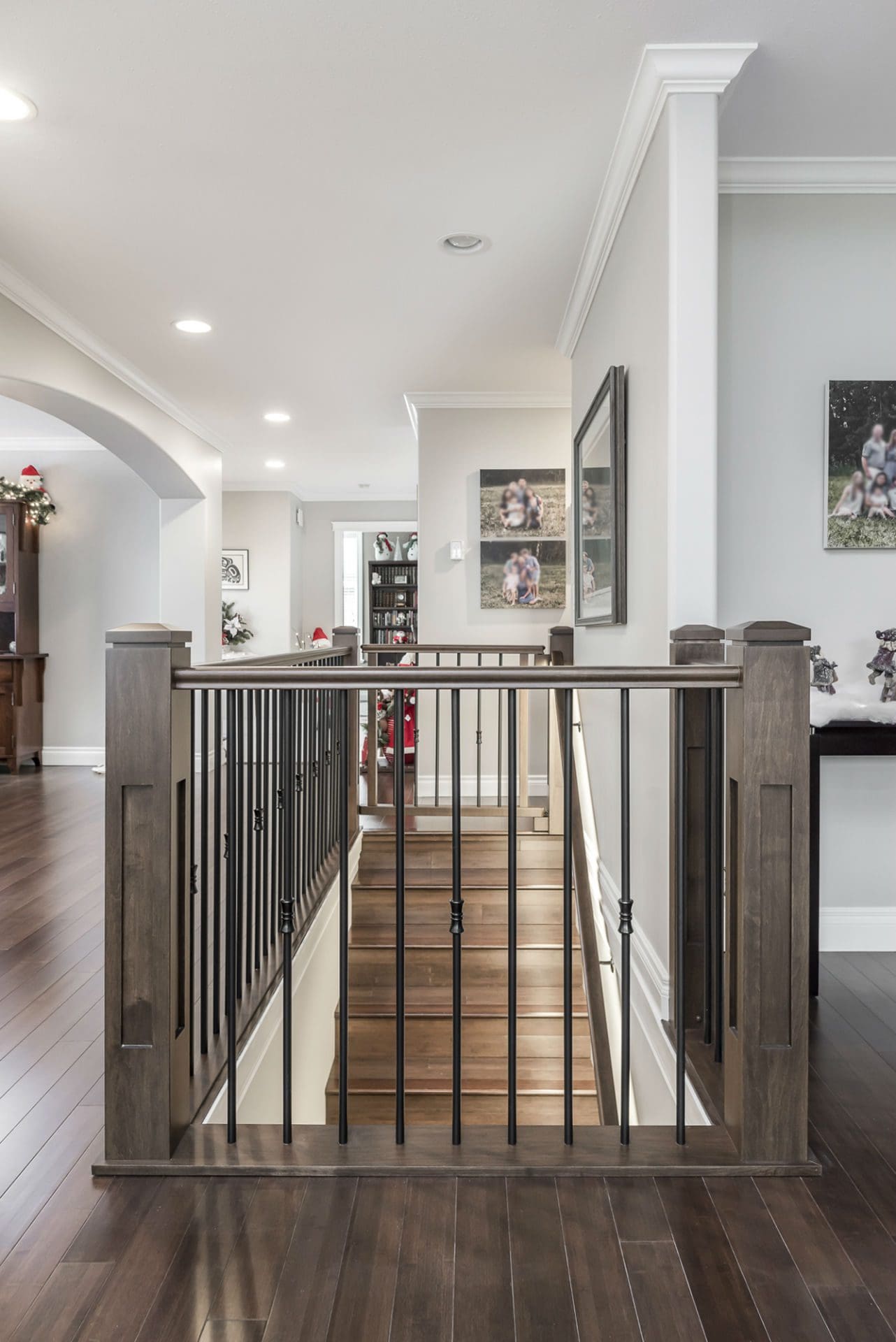 Custom stair railing with iron balusters and wood posts Chilliwack home renovation