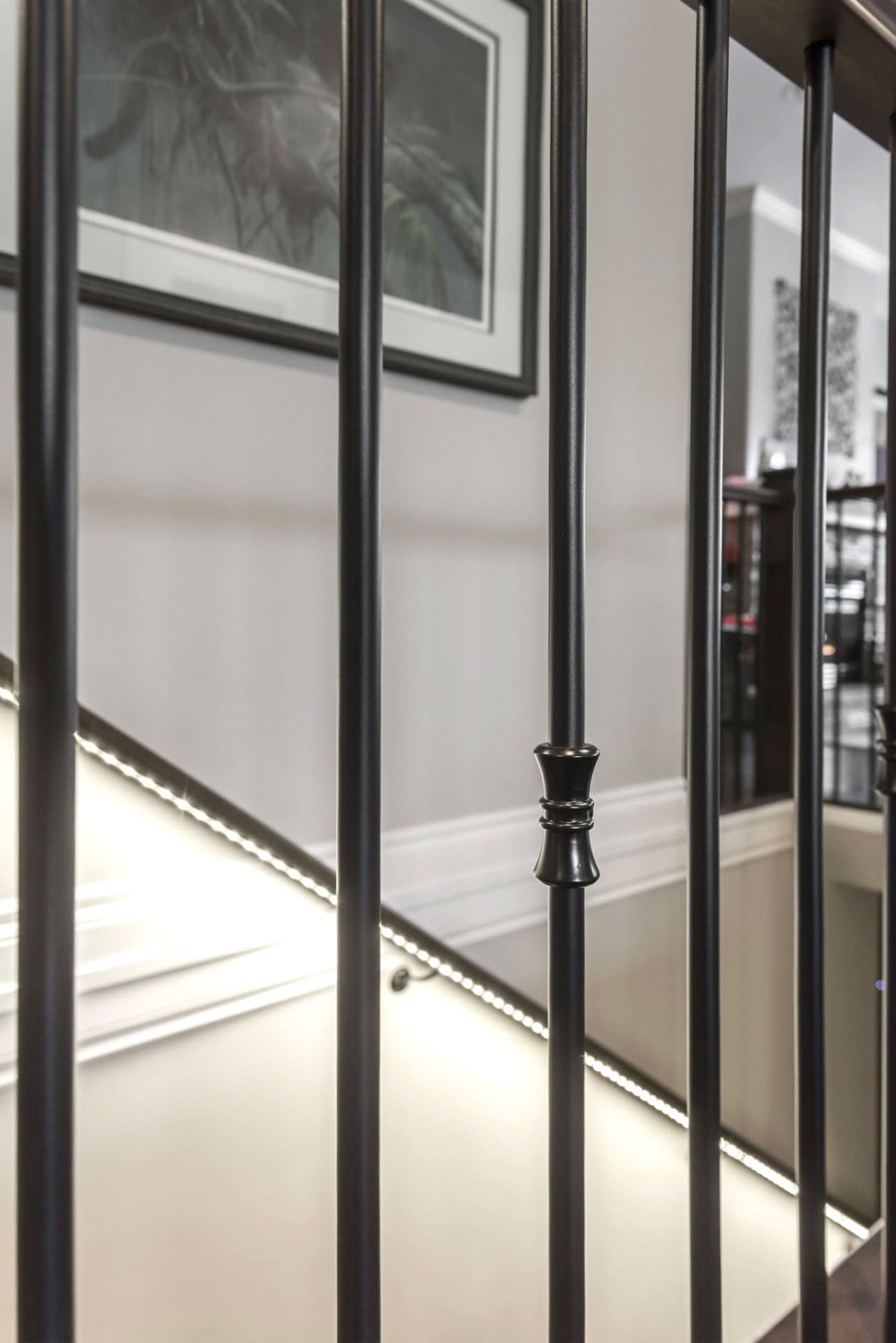 Iron baluster spindle detail with LED stair lighting Chilliwack renovation