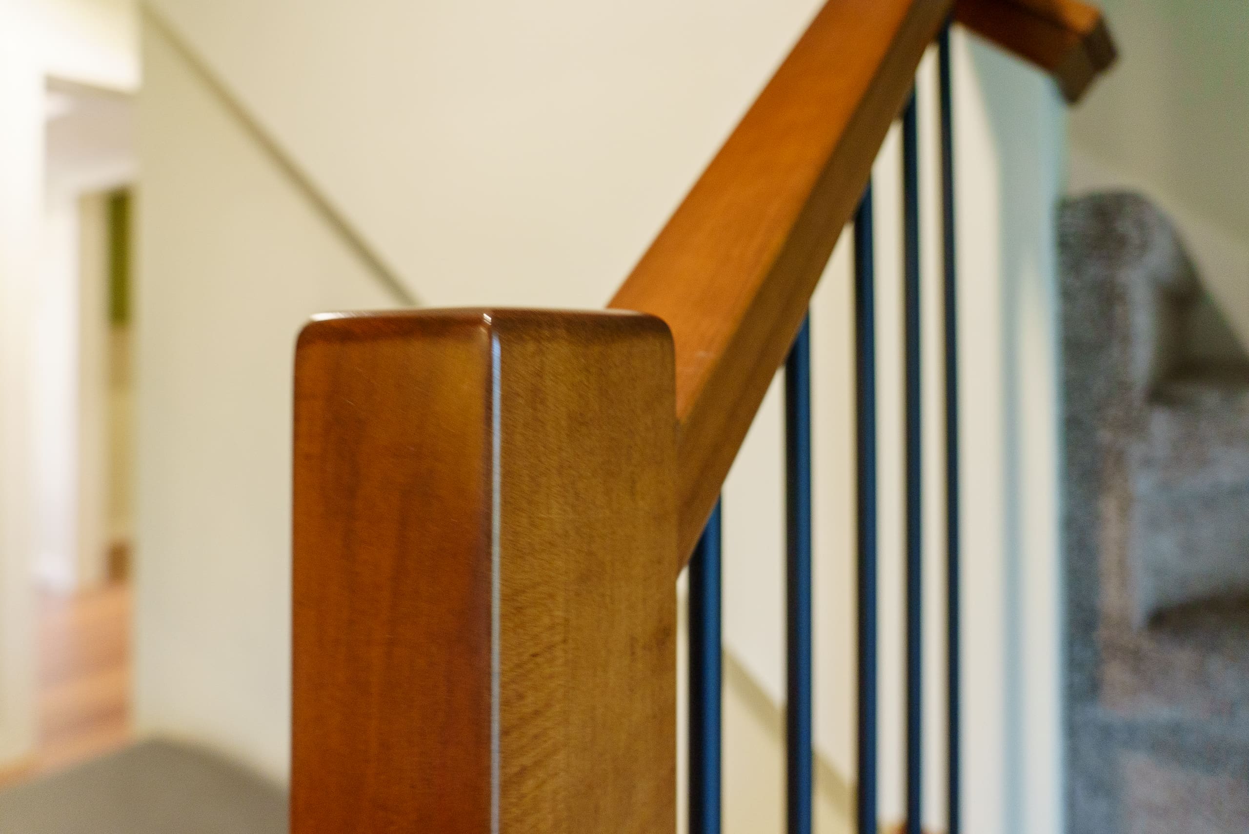 Polished wood railing post with black iron balusters Yarrow renovation