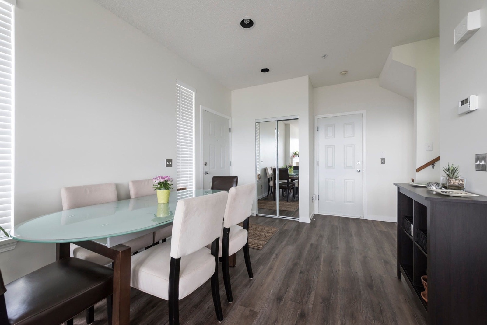 Bright, airy dining space with white walls and natural light
