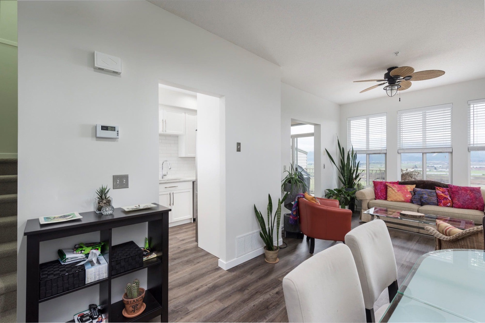 Elegant living room renovation with professionally painted walls, modern furnishings, and warm natural lighting in a Fraser Valley home